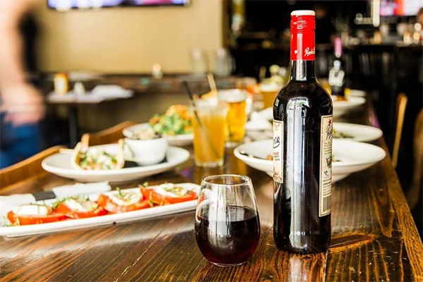 wine and multiple entrees on the patio at cypress street in midtown | 817 W Peachtree St NW, Atlanta, GA 30308