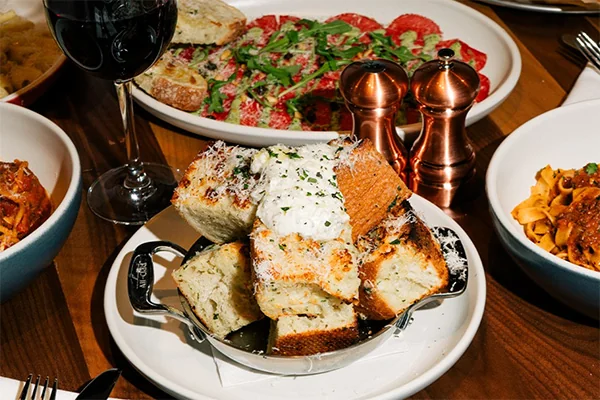 garlic bread and other menu items on the table at north Italia | 3393 Peachtree Rd NE, Atlanta, GA 30326